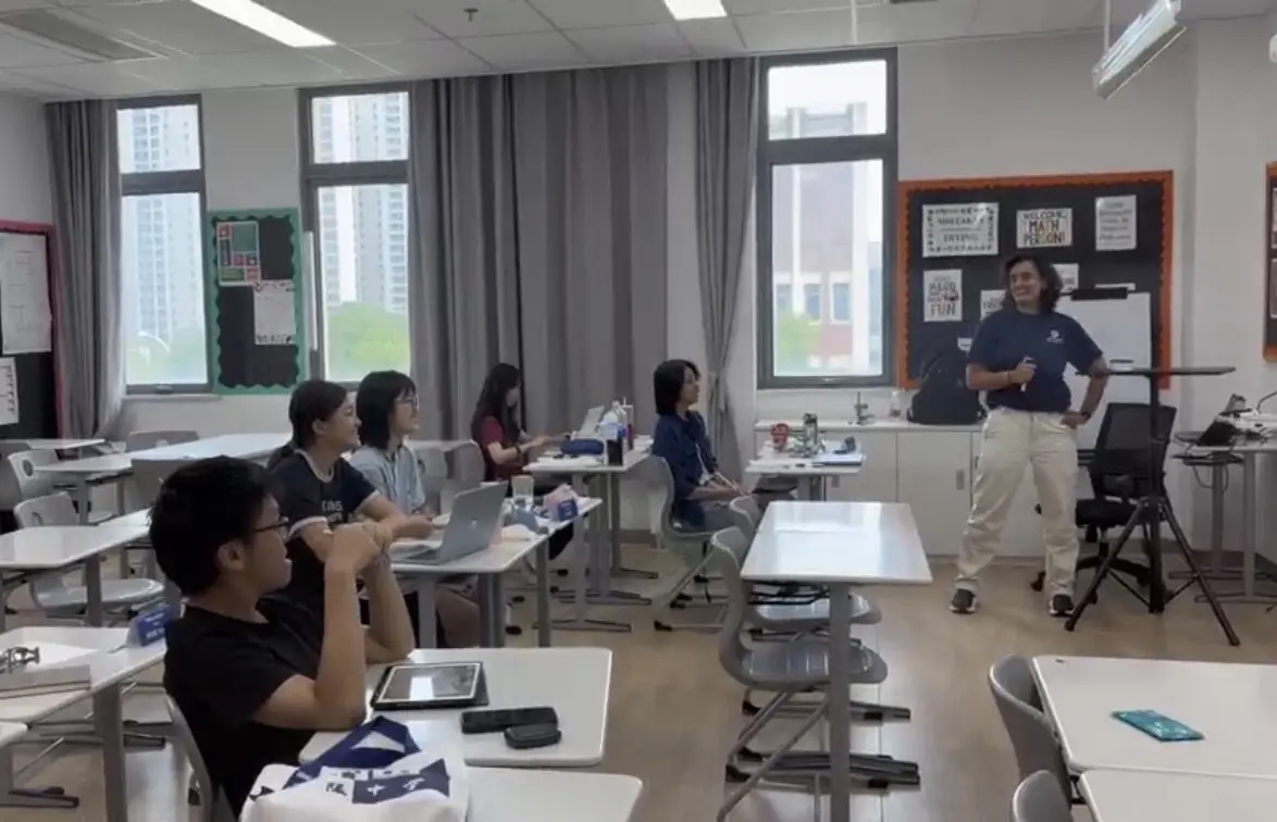 Arij teaching mathematics to a classroom of students