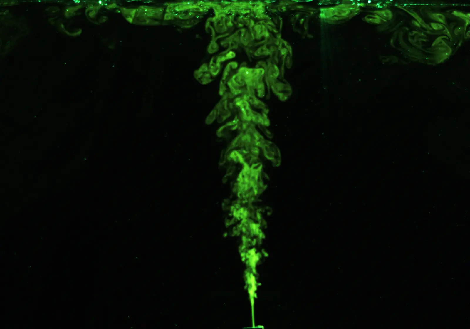 Fluorescent laboratory image of a turbulent buoyant plume impinging on a ceiling